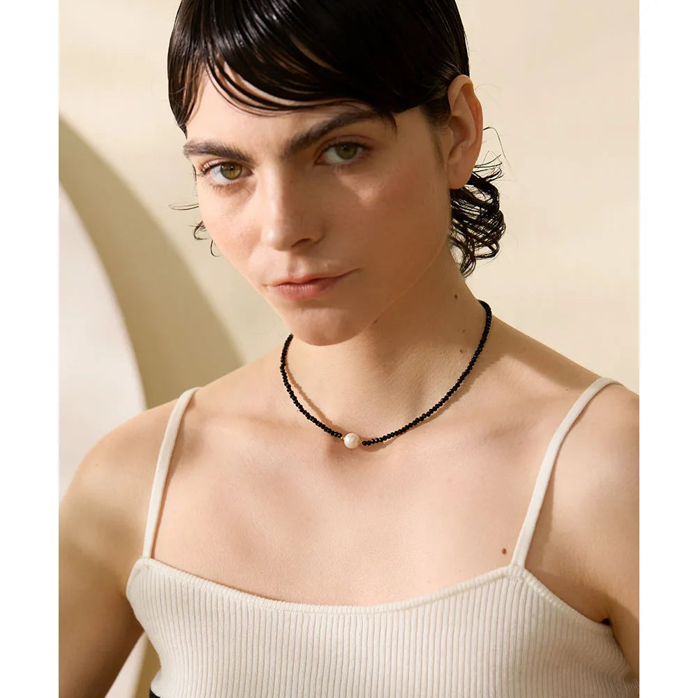 Noirelle necklace close-up showing textured oval detail