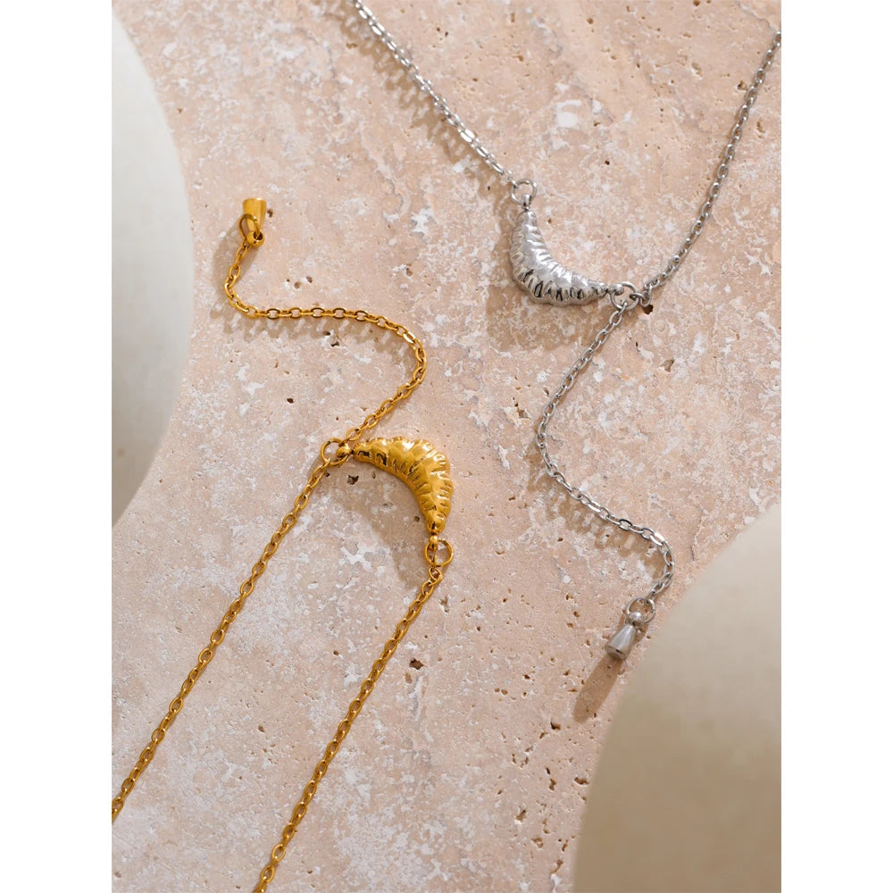 Close-up of polished gold-tone necklace surface