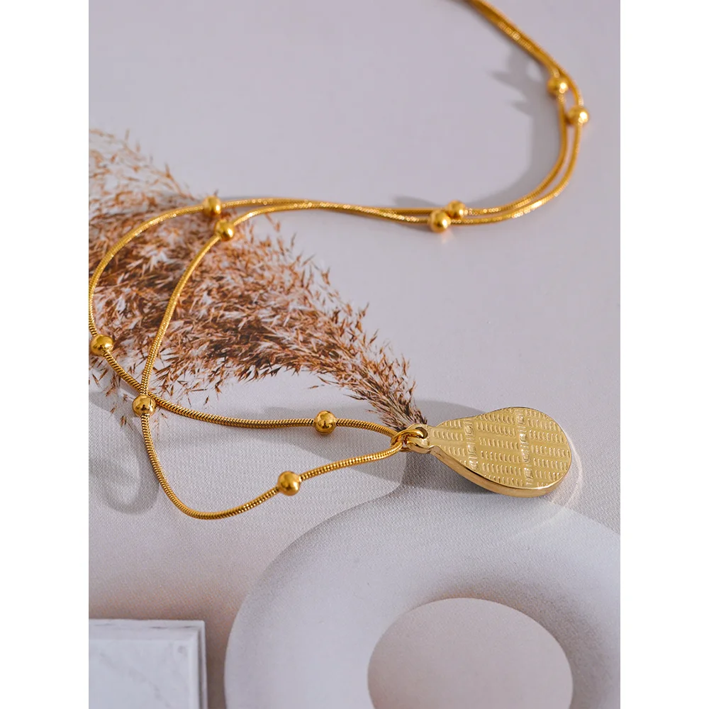 Tigris necklace detail view showing oval pendant