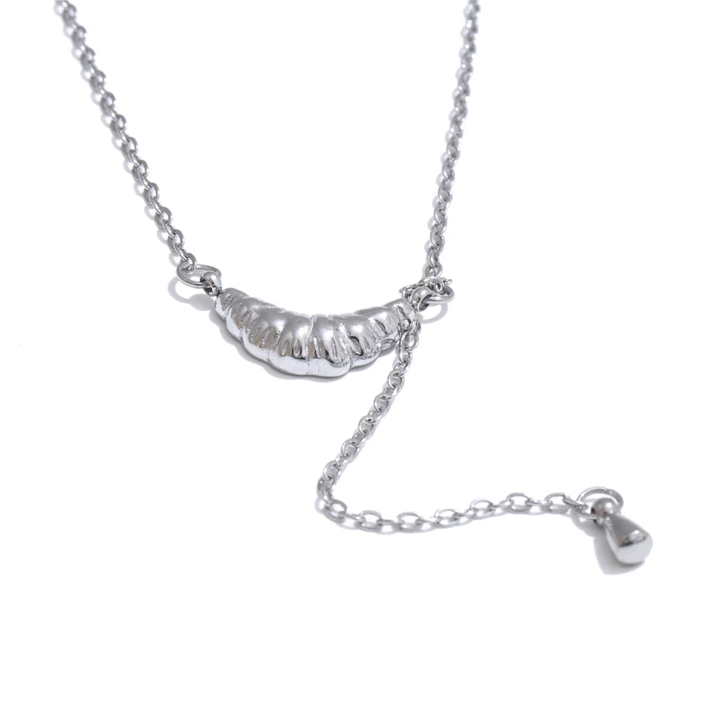 Croisette necklace detail view showing heart pendant
