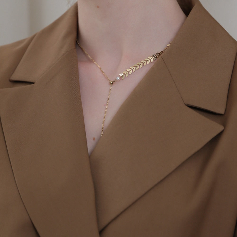 Tanir necklace close-up showing textured oval detail