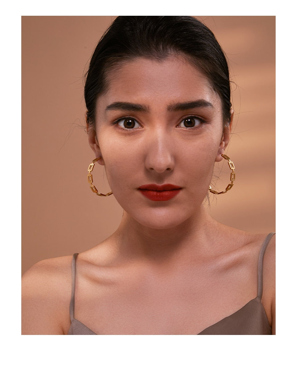 Nilash earrings detail view showing oval drop