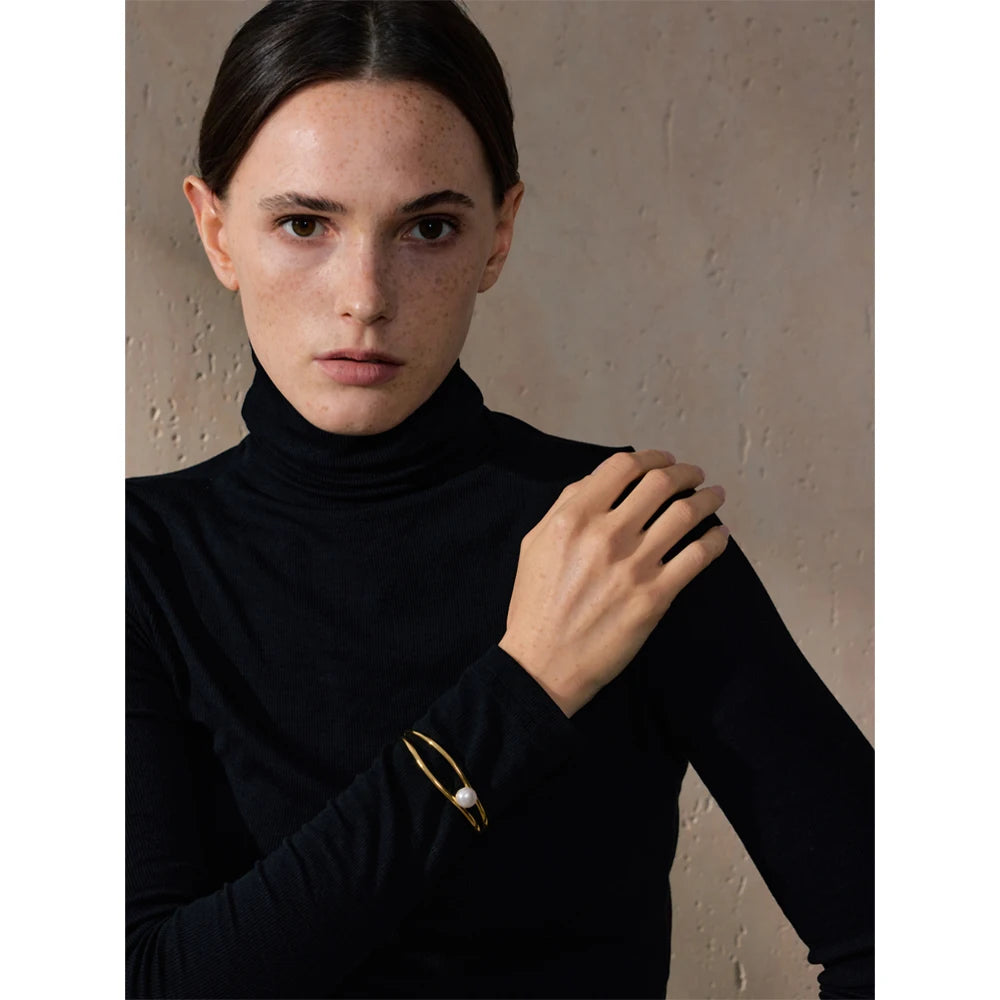 Ilda bracelet side view showing smooth cuff silhouette