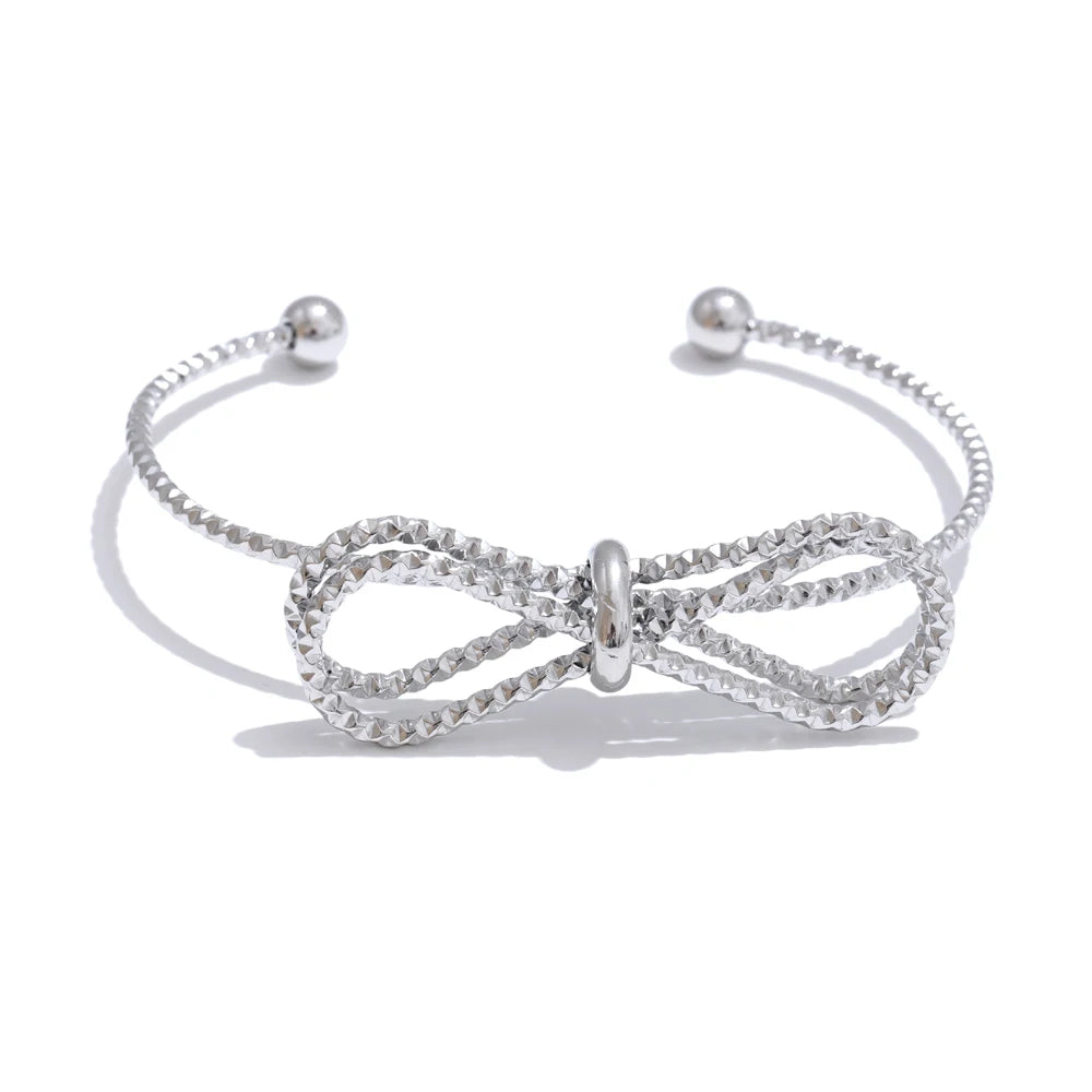 Gold stainless steel adjustable open cuff bracelet with bow-knot detail