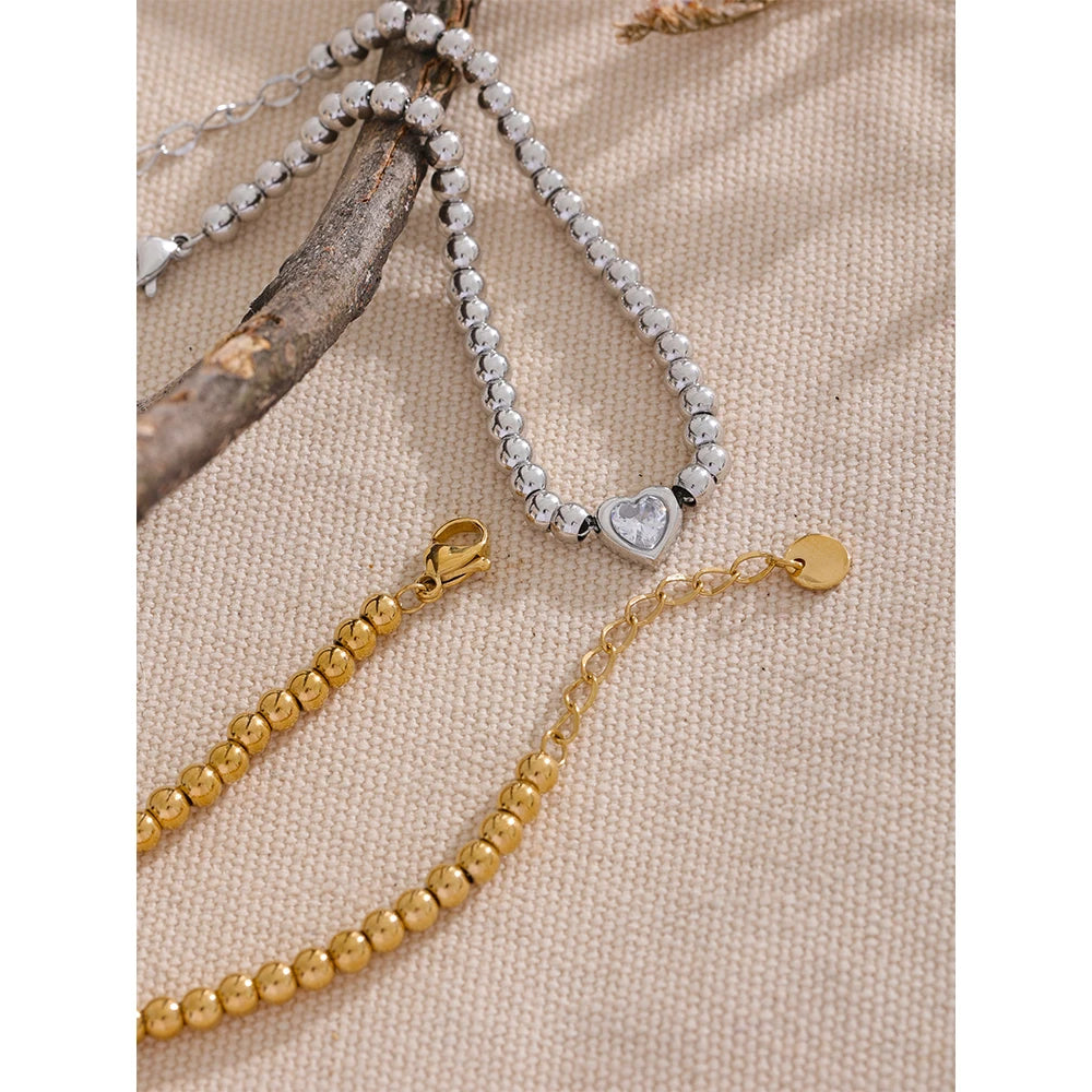 Mina bracelet close-up showing heart-shaped zircon detail